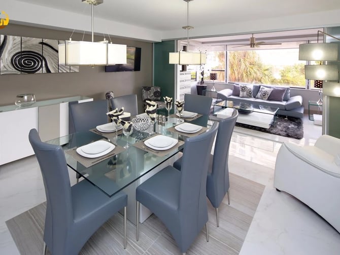 Comedor y sala de estar de planta abierta con mesa de cristal, sillas grises, sofá morado y vistas al mar a través de grandes ventanales
